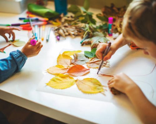 Children doing autumn handcrafts